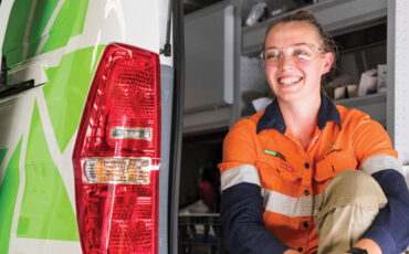 Team member sitting in the back of a work van