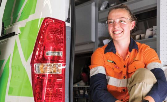 Team member sitting in the back of a work van